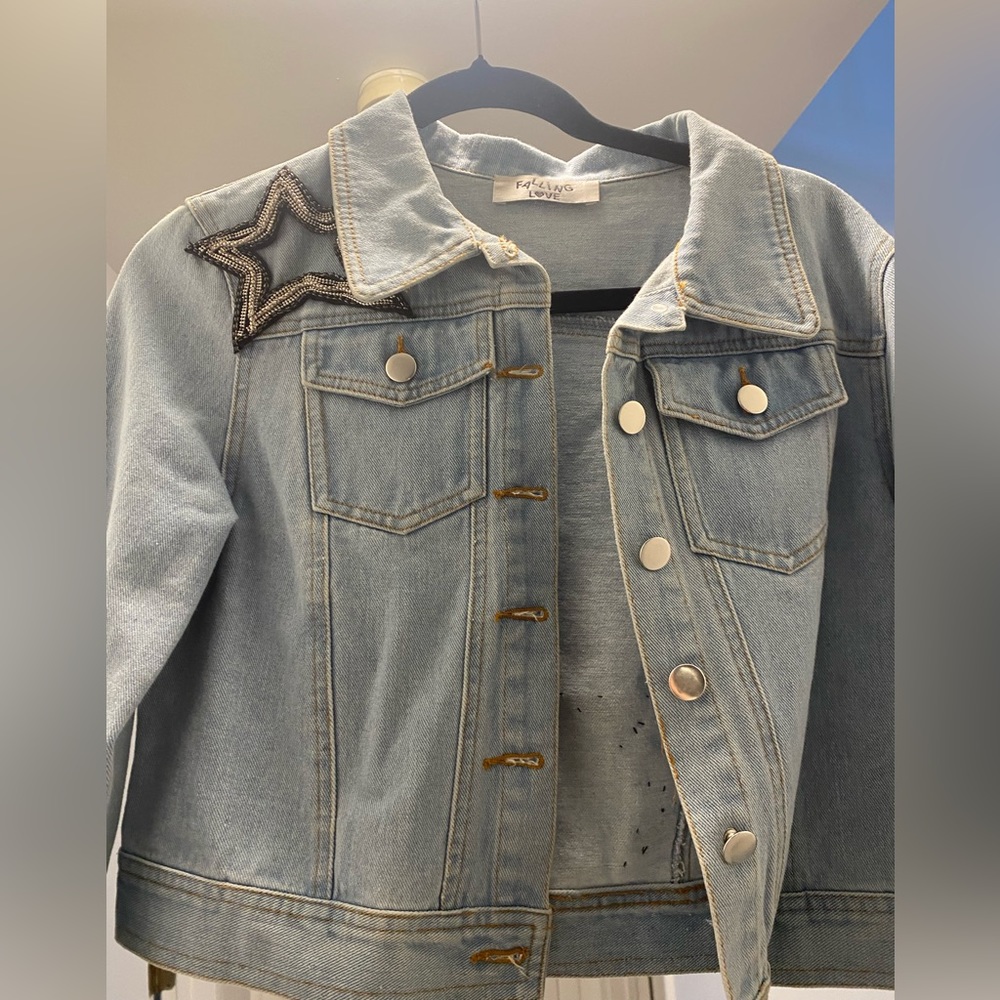 Light wash cropped denim jacket with star embellishments